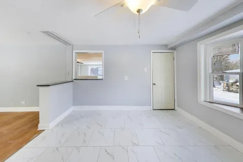 an empty room with windows and entrance