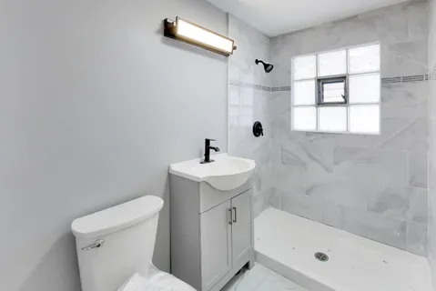 a bathroom with a sink toilet and shower