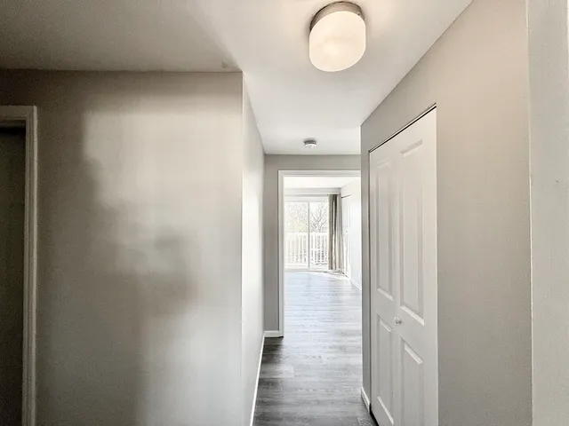 a view of a room with wooden floor