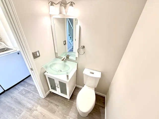 a bathroom with a toilet a sink and a mirror