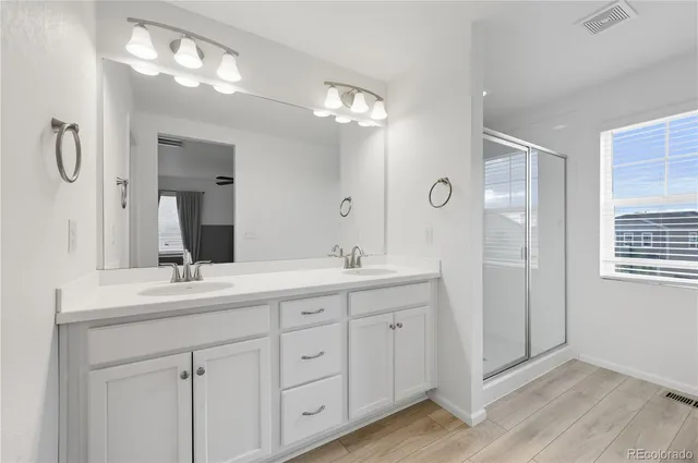 a bathroom with a double vanity sink and a mirror
