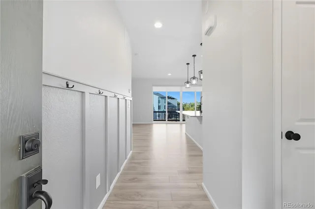 a view of a hallway with furniture and a entryway