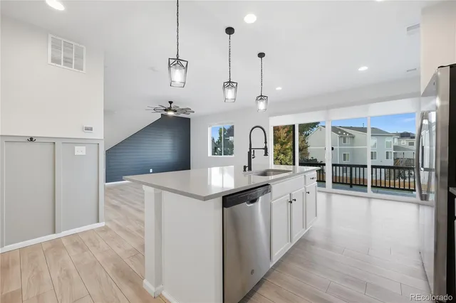 a kitchen with counter top space and wooden floor