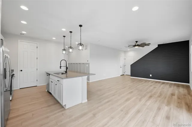 a kitchen with a sink and chandelier