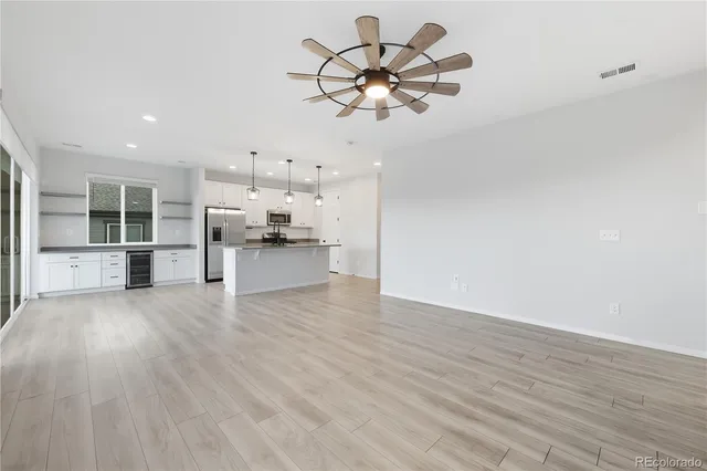 a view of a kitchen with a sink dishwasher a refrigerator and cabinets