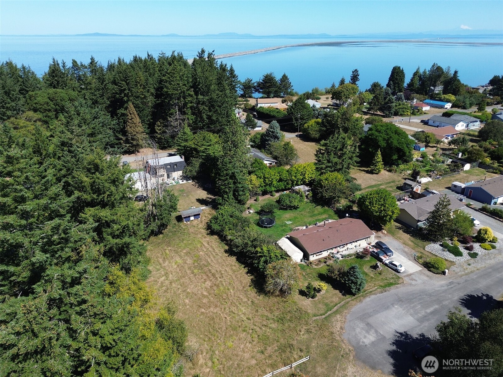 999 Bay View Street Sequim, WA 98382 - Photo 1 of 26 an aerial view of a house with a yard and lake view
