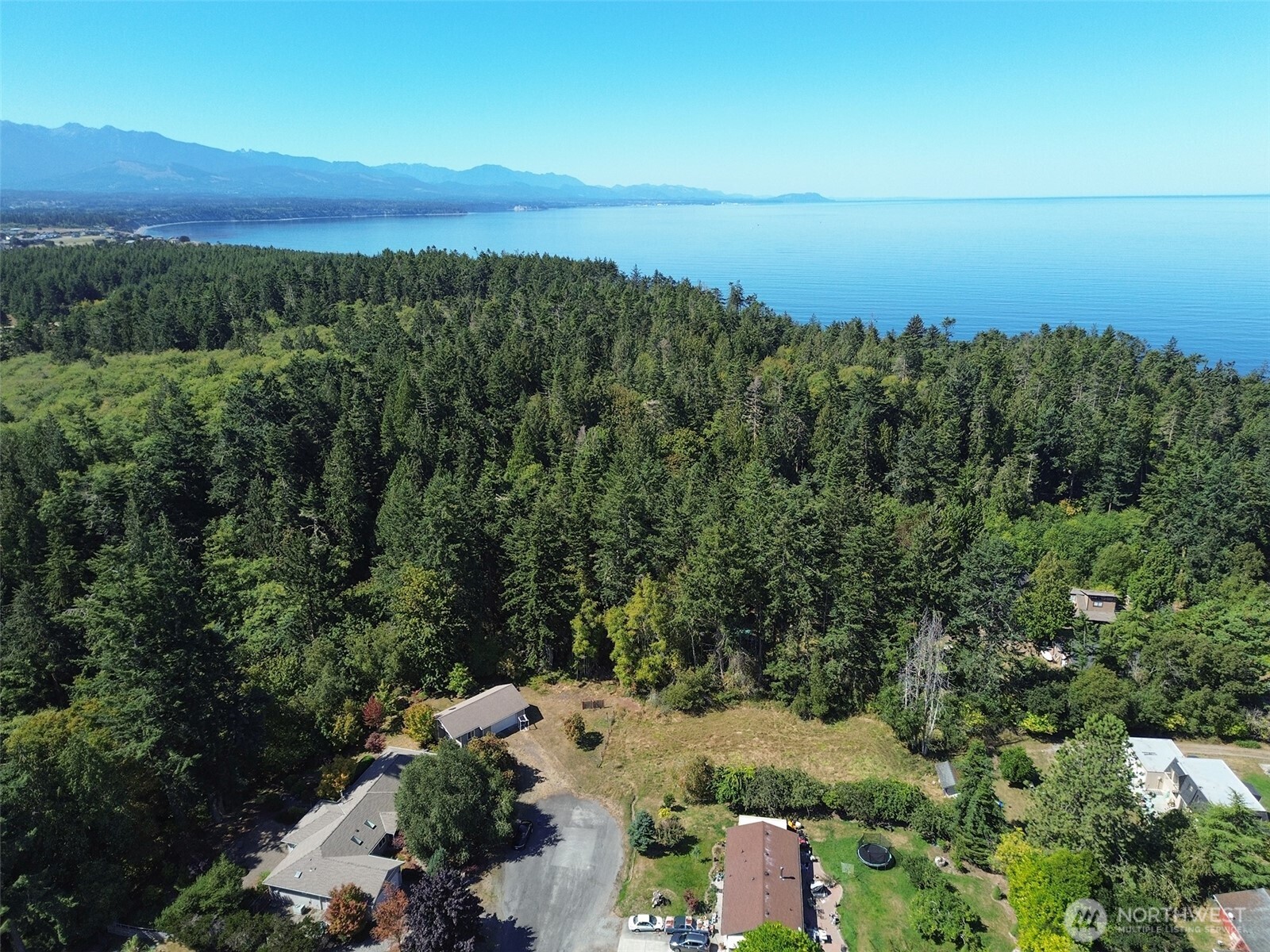 999 Bay View Street Sequim, WA 98382 - Photo 25 of 26 an aerial view of a city with lots of residential buildings and mountain view in back