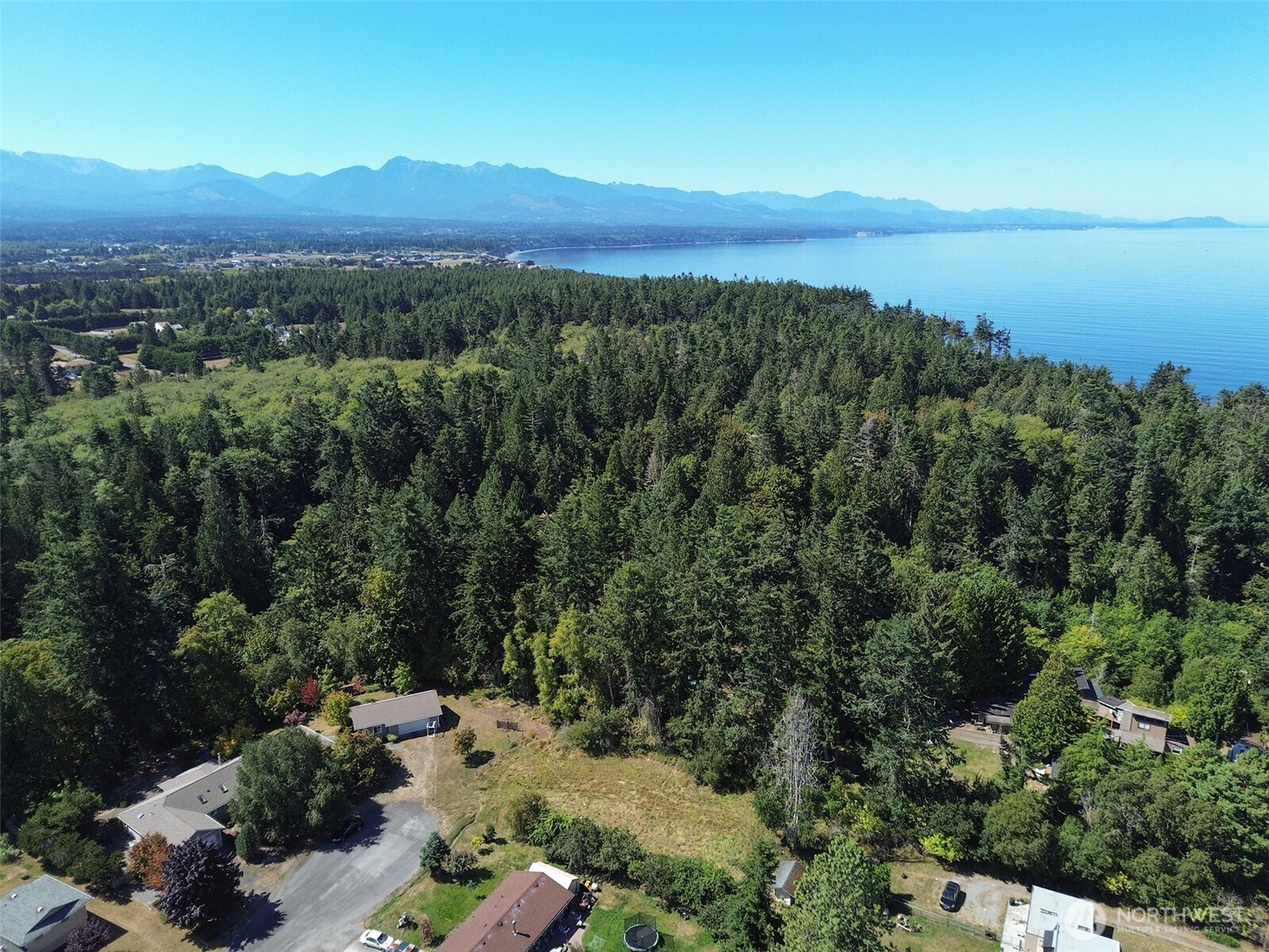 999 Bay View Street Sequim, WA 98382 - Photo 26 of 26 an aerial view of a city with lots of residential buildings and mountain view in back