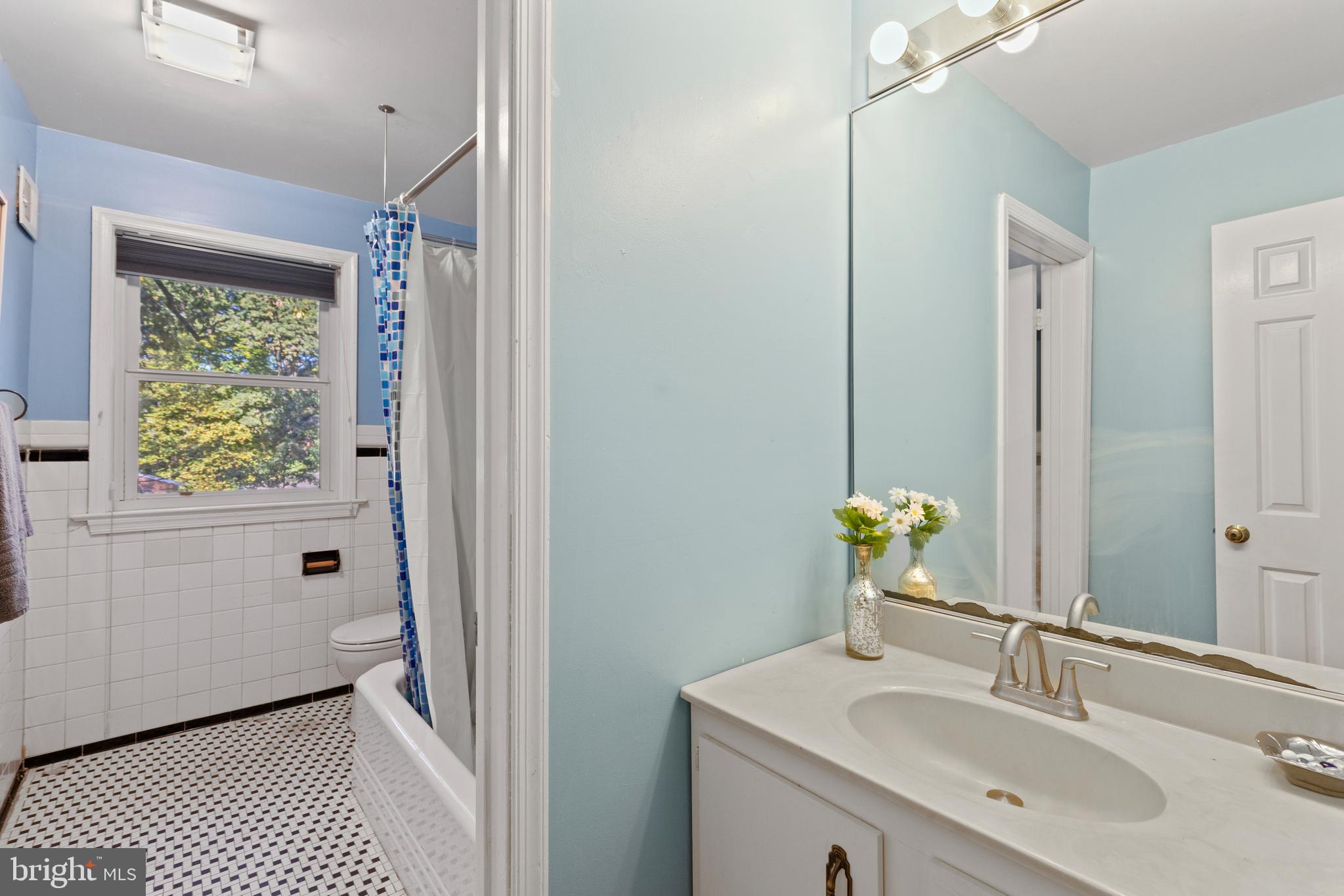 8547 Bradford Road, Unit 92 Silver Spring, MD 20901 - Photo 13 of 24 a bathroom with a sink toilet and shower