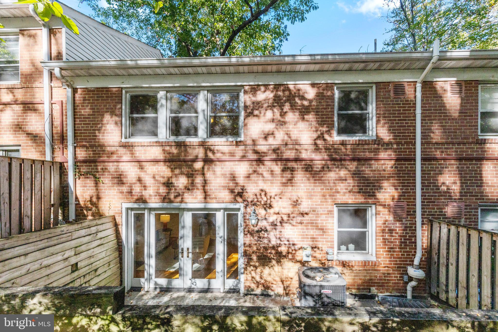 8547 Bradford Road, Unit 92 Silver Spring, MD 20901 - Photo 16 of 24 a front view of a house with large windows