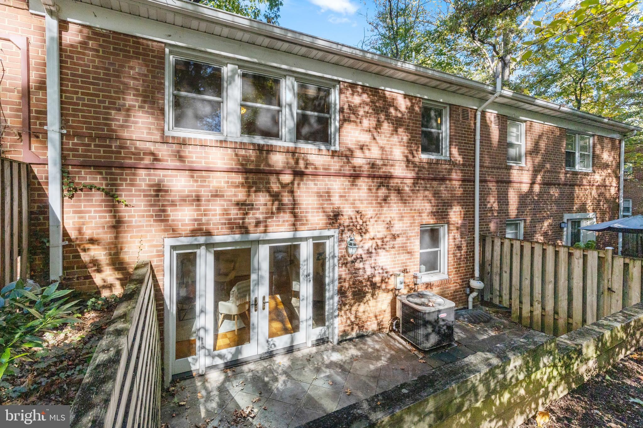8547 Bradford Road, Unit 92 Silver Spring, MD 20901 - Photo 17 of 24 a front view of a house with a yard