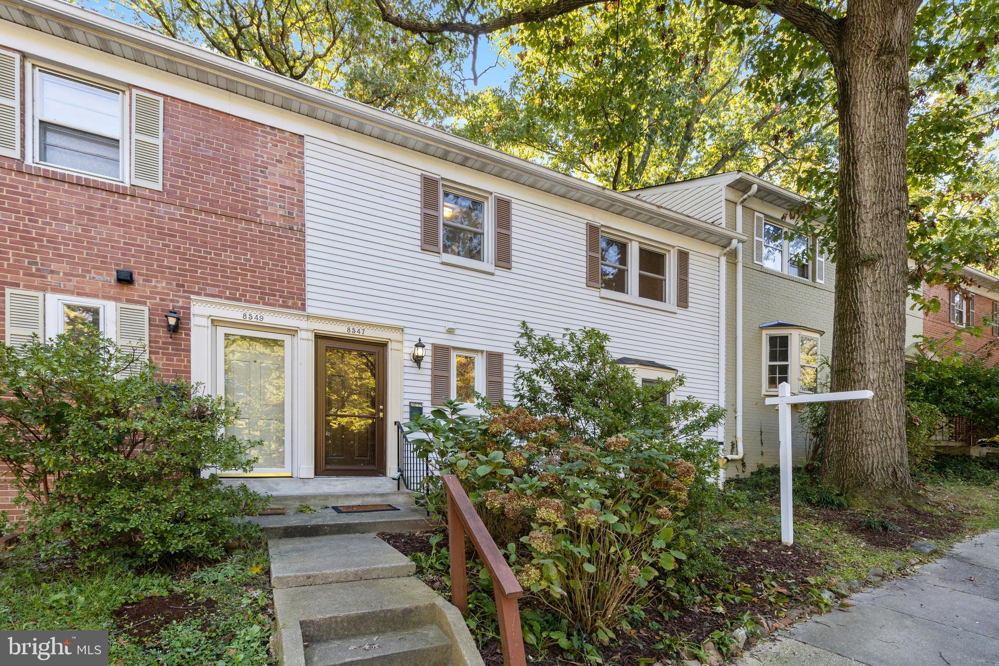 8547 Bradford Road, Unit 92 Silver Spring, MD 20901 - Photo 20 of 24 a front view of a house with trees