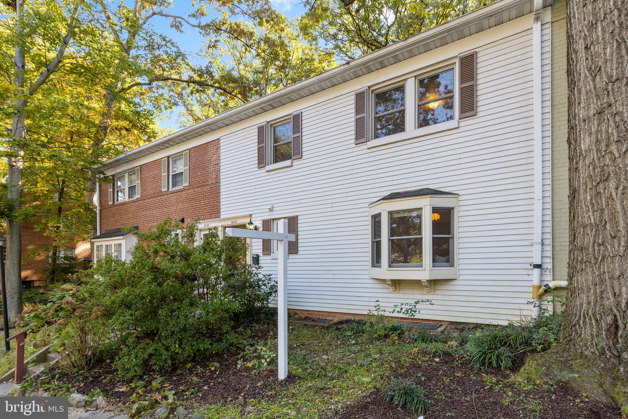 8547 Bradford Road, Unit 92 Silver Spring, MD 20901 - Photo 21 of 24 a view of a house with a yard and potted plants