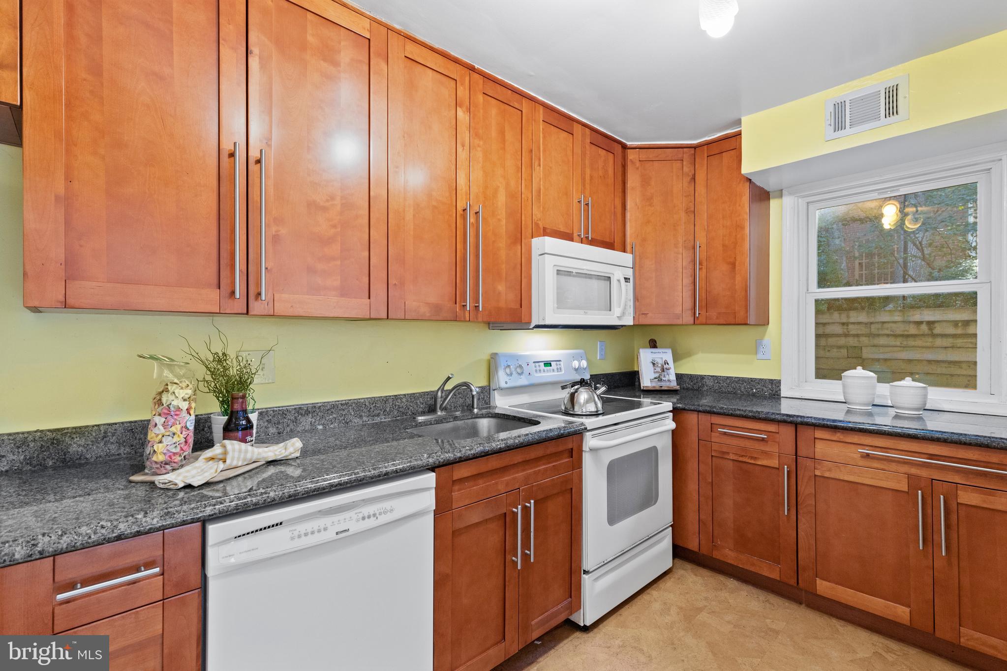 8547 Bradford Road, Unit 92 Silver Spring, MD 20901 - Photo 5 of 24 a kitchen with stainless steel appliances granite countertop a sink stove and cabinets