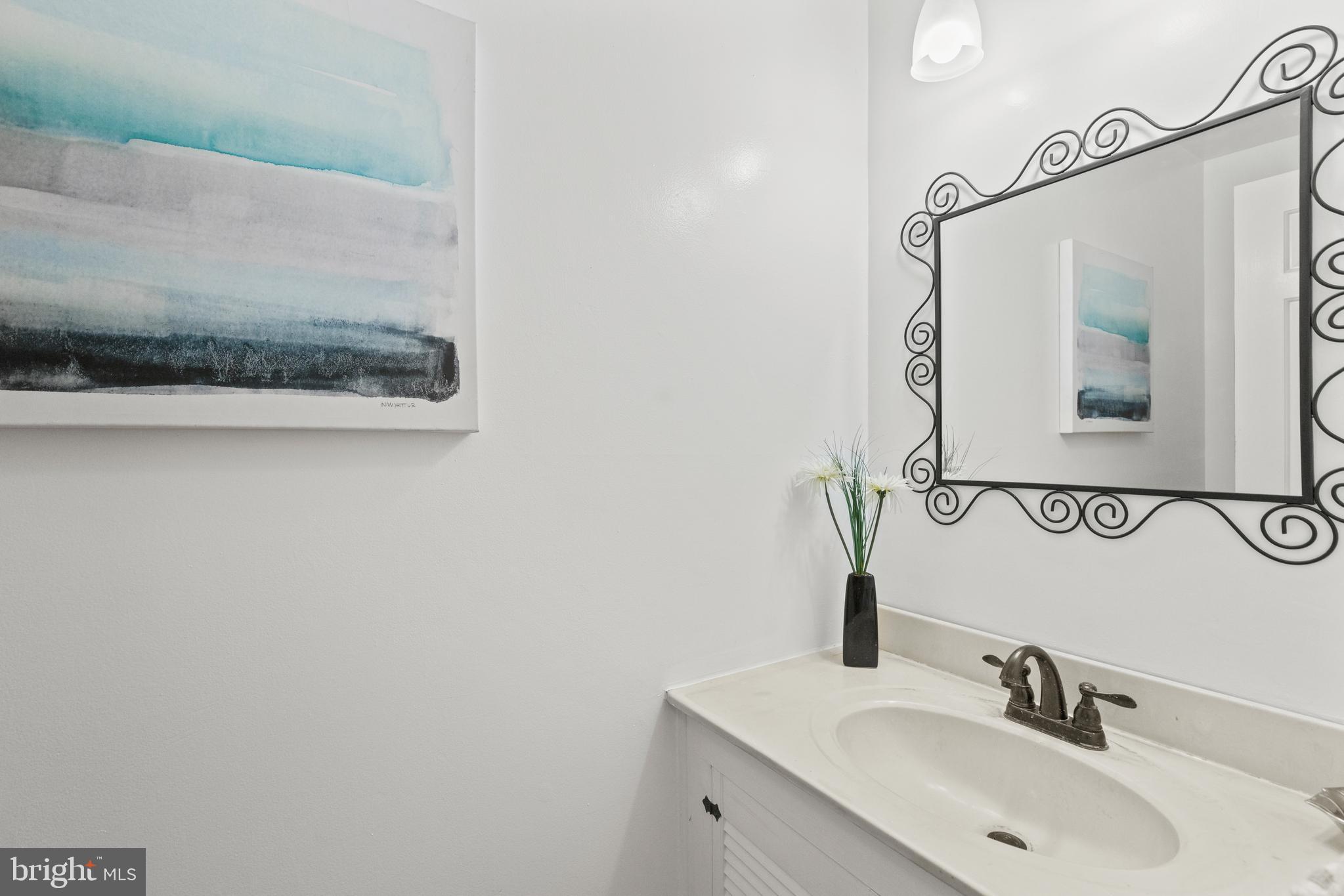 8547 Bradford Road, Unit 92 Silver Spring, MD 20901 - Photo 8 of 24 a bathroom with a sink and a mirror