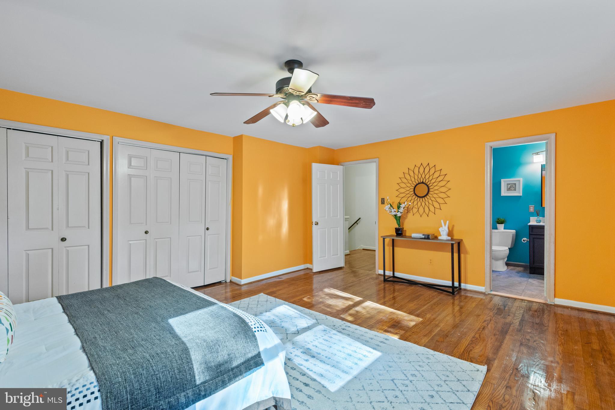 8547 Bradford Road, Unit 92 Silver Spring, MD 20901 - Photo 10 of 24 a bedroom with a bed and a chandelier