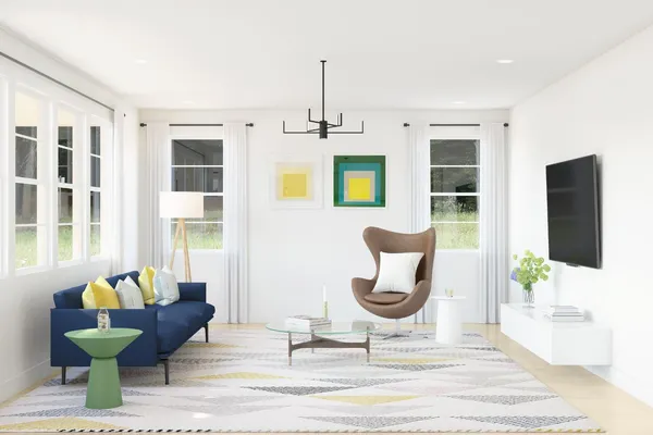 a living room with furniture and a potted plant