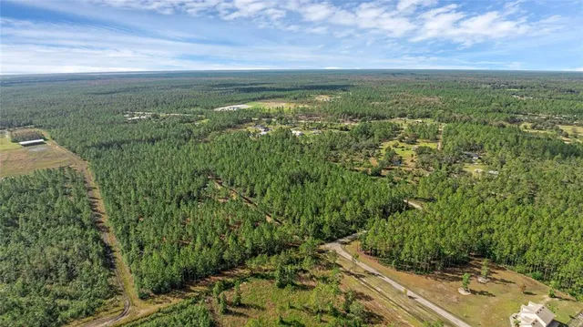 a view of a field with an ocean view
