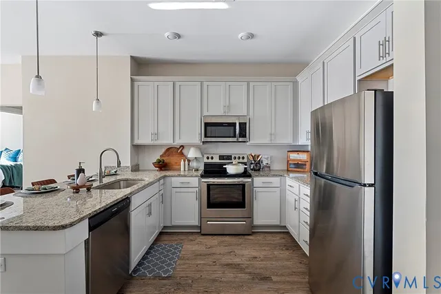 a kitchen with a sink appliances a refrigerator and a sink