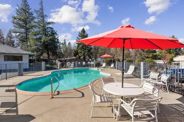 a patio with a table and chairs under an umbrella