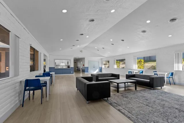 a living room with furniture a couch and a piano