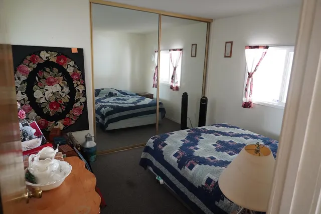 a bedroom with bed and a window