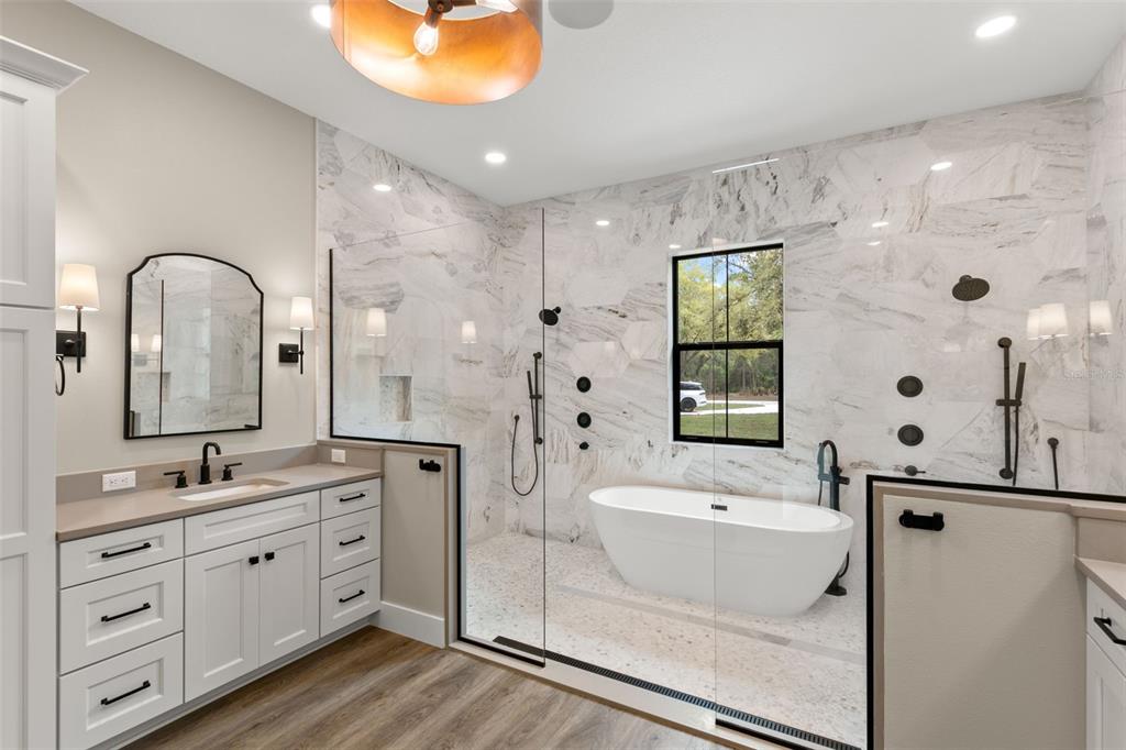 0 Plainview Road, Unit LOT 2 Odessa, FL 33556 - Photo 12 of 21 a spacious bathroom with a double vanity sink a mirror a bathtub and shower