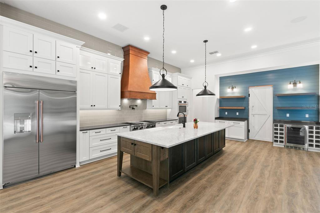 0 Plainview Road, Unit LOT 2 Odessa, FL 33556 - Photo 9 of 21 a large kitchen with kitchen island a sink stainless steel appliances and cabinets