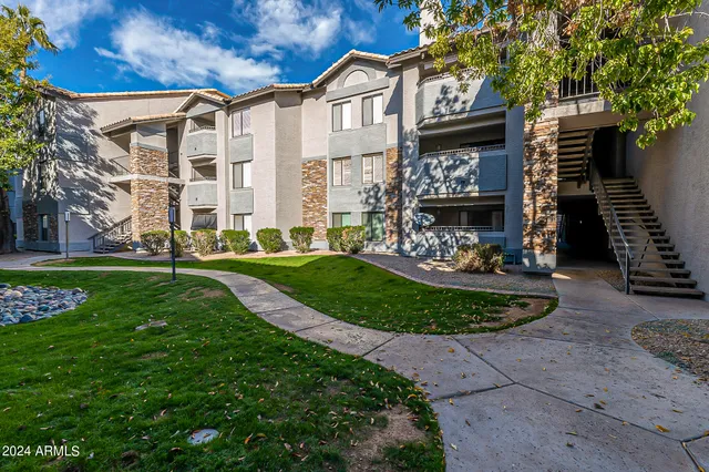 a front view of a building with a garden