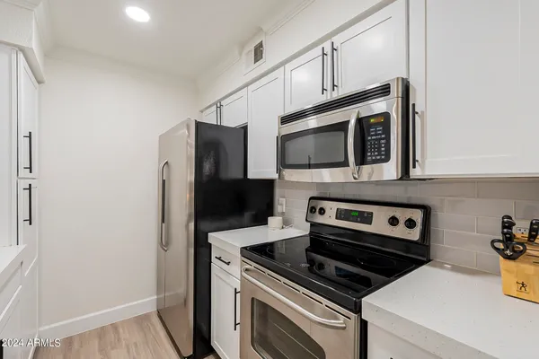 a kitchen with a stove and a microwave