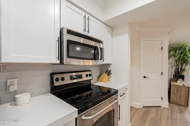 a kitchen with a stove and a microwave