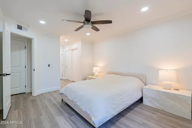 a bedroom with a bed and a chandelier