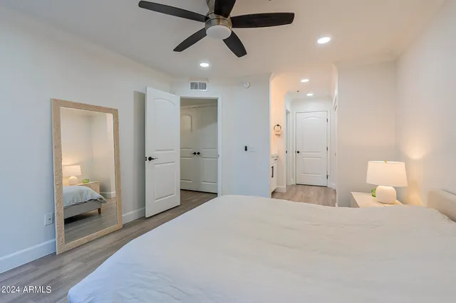 a bedroom with a large bed and a chandelier