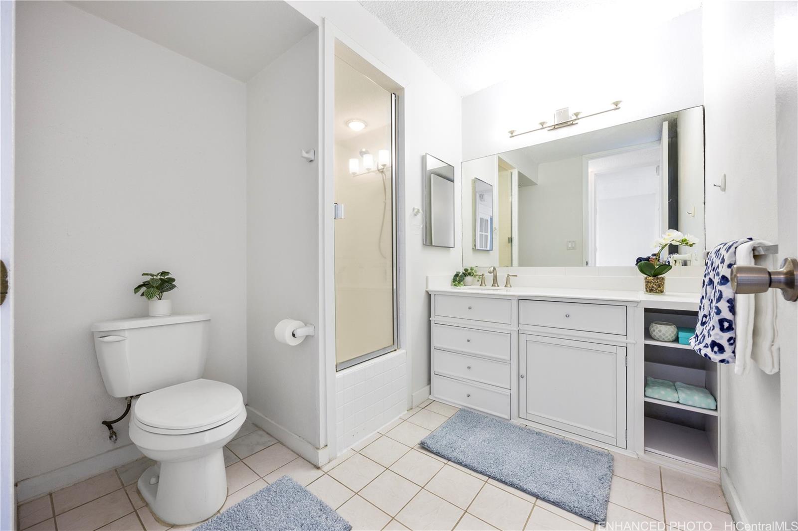620 McCully Street, Unit 902 Honolulu, HI 96826 - Photo 11 of 23 a bathroom with a toilet a sink and mirror