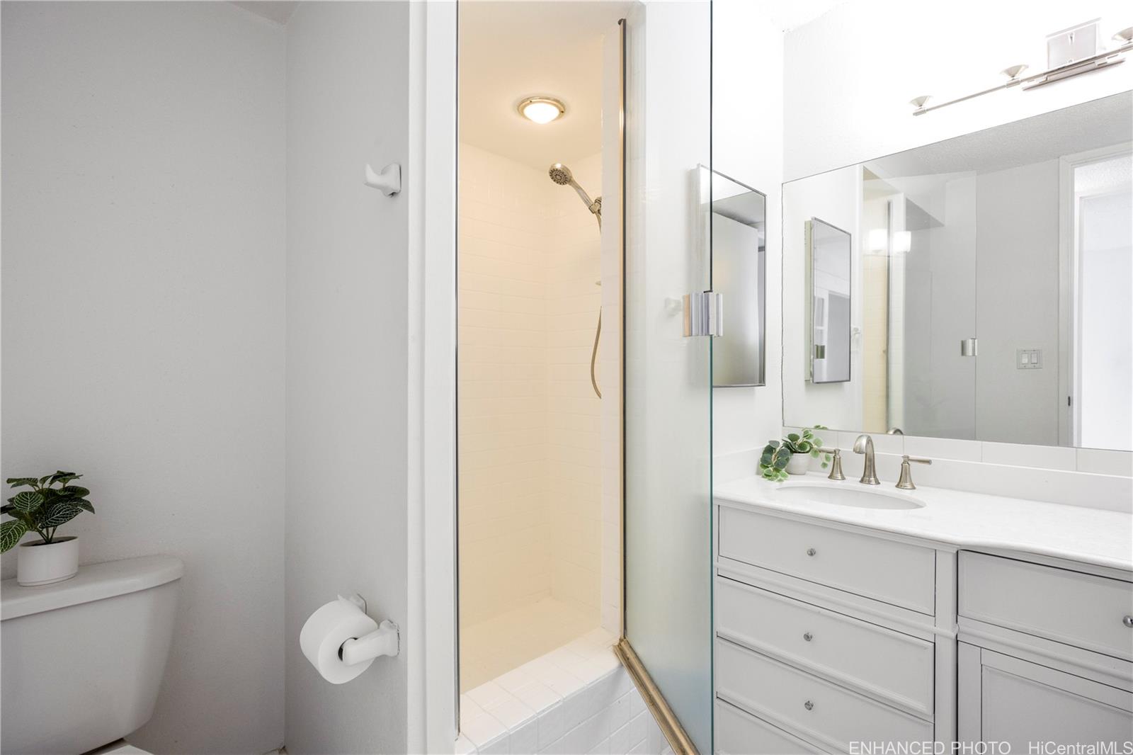 620 McCully Street, Unit 902 Honolulu, HI 96826 - Photo 12 of 23 a bathroom with a double vanity sink toilet and shower
