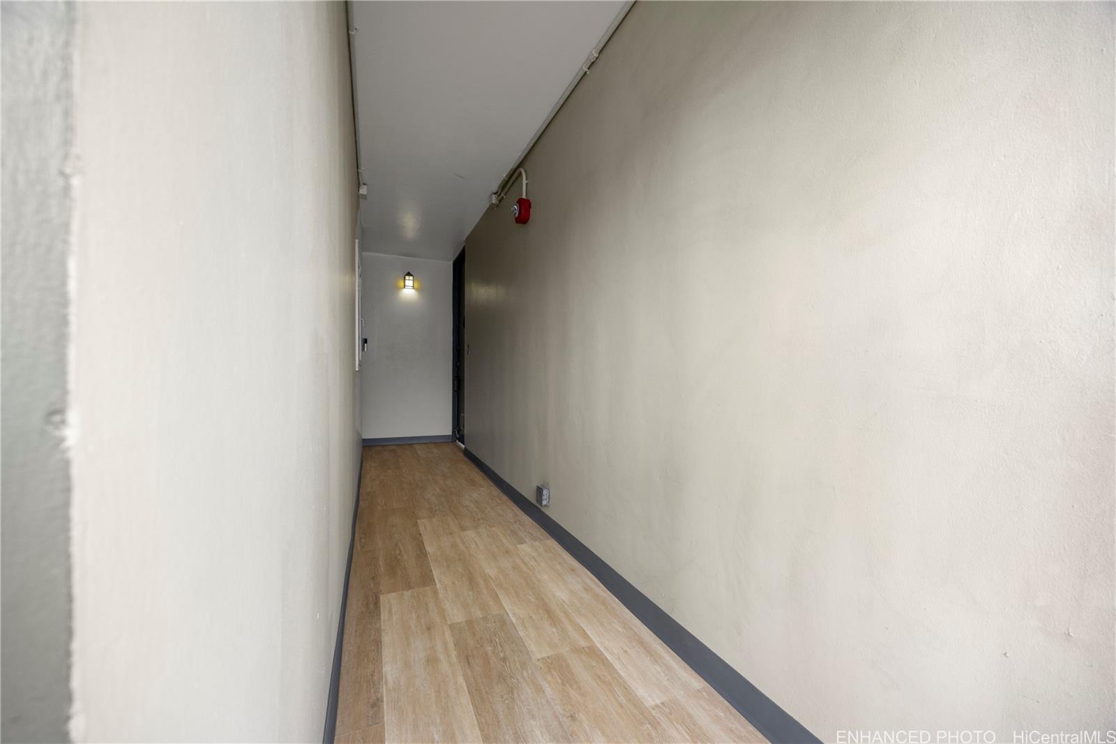 620 McCully Street, Unit 902 Honolulu, HI 96826 - Photo 19 of 23 a view of a hallway with wooden floor