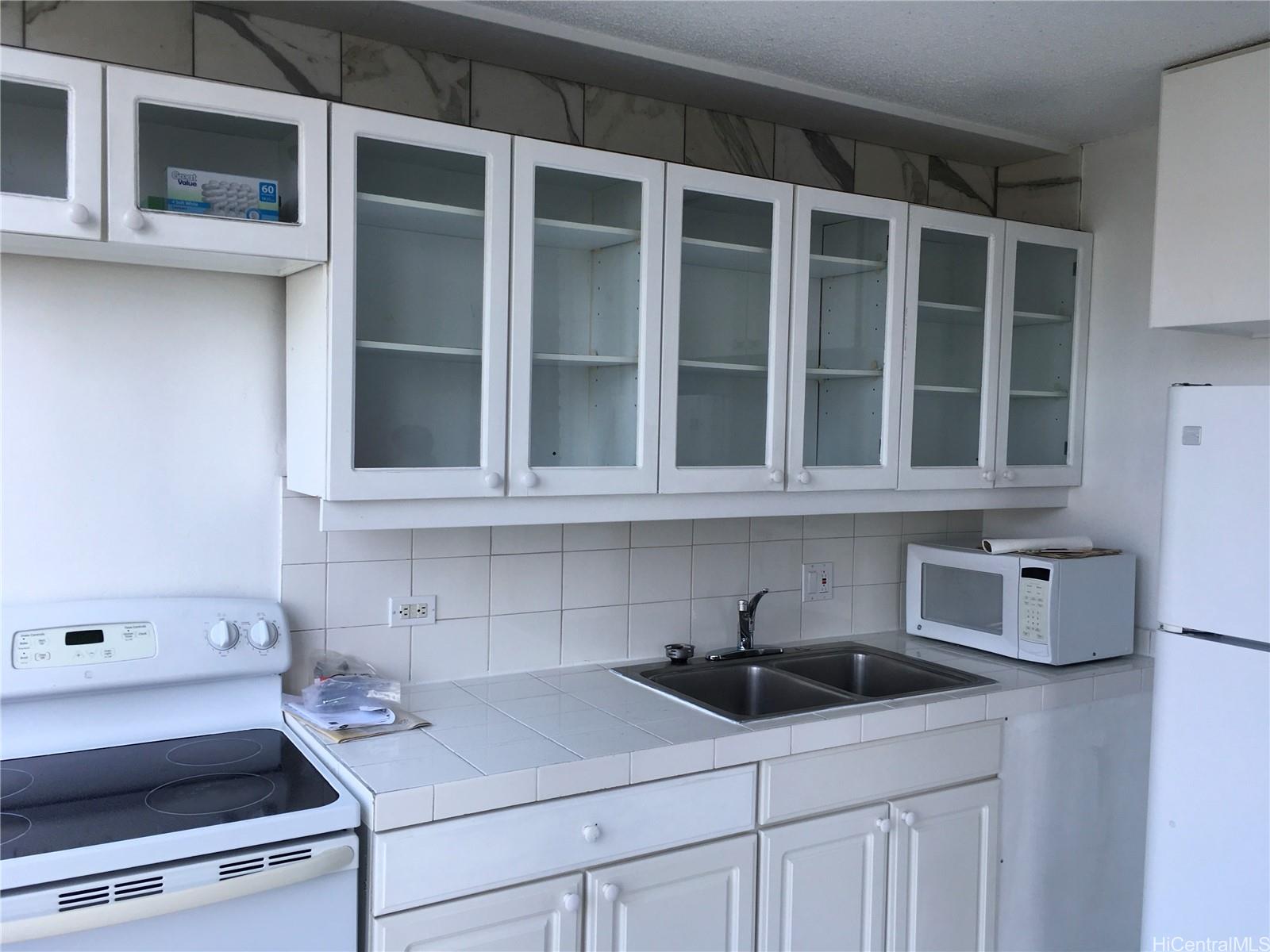 620 McCully Street, Unit 902 Honolulu, HI 96826 - Photo 2 of 14 a kitchen with stainless steel appliances granite countertop a sink and a stove