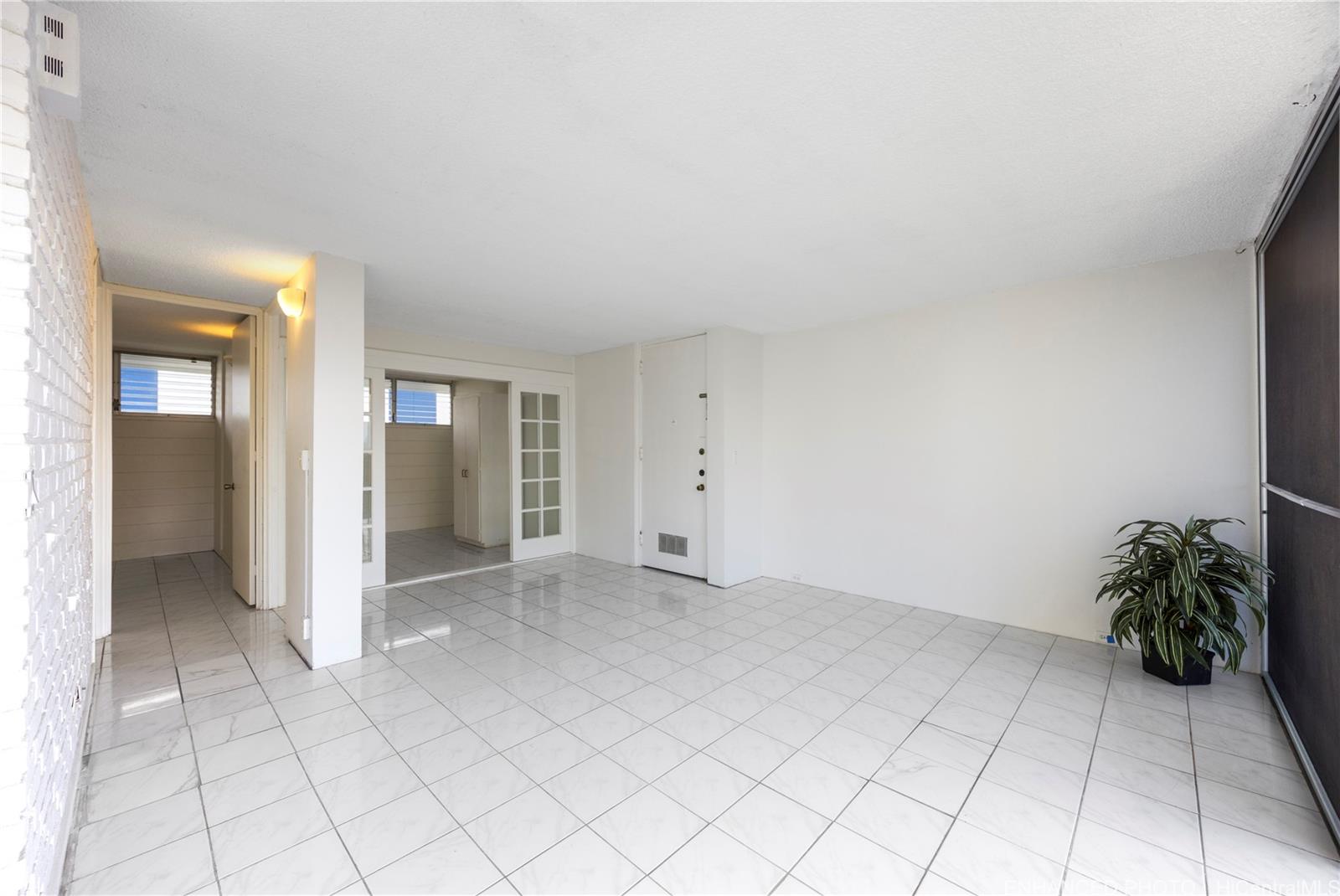 620 McCully Street, Unit 902 Honolulu, HI 96826 - Photo 5 of 23 an empty room with windows