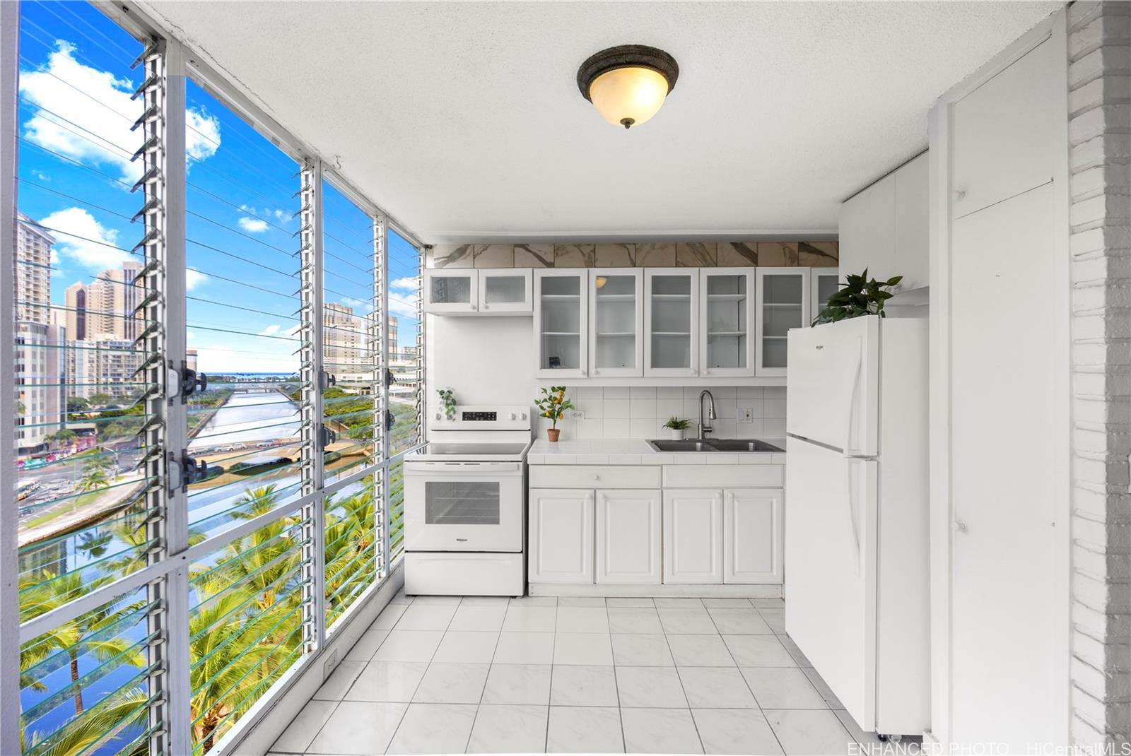 620 McCully Street, Unit 902 Honolulu, HI 96826 - Photo 6 of 23 a kitchen with stainless steel appliances a stove a sink and a refrigerator