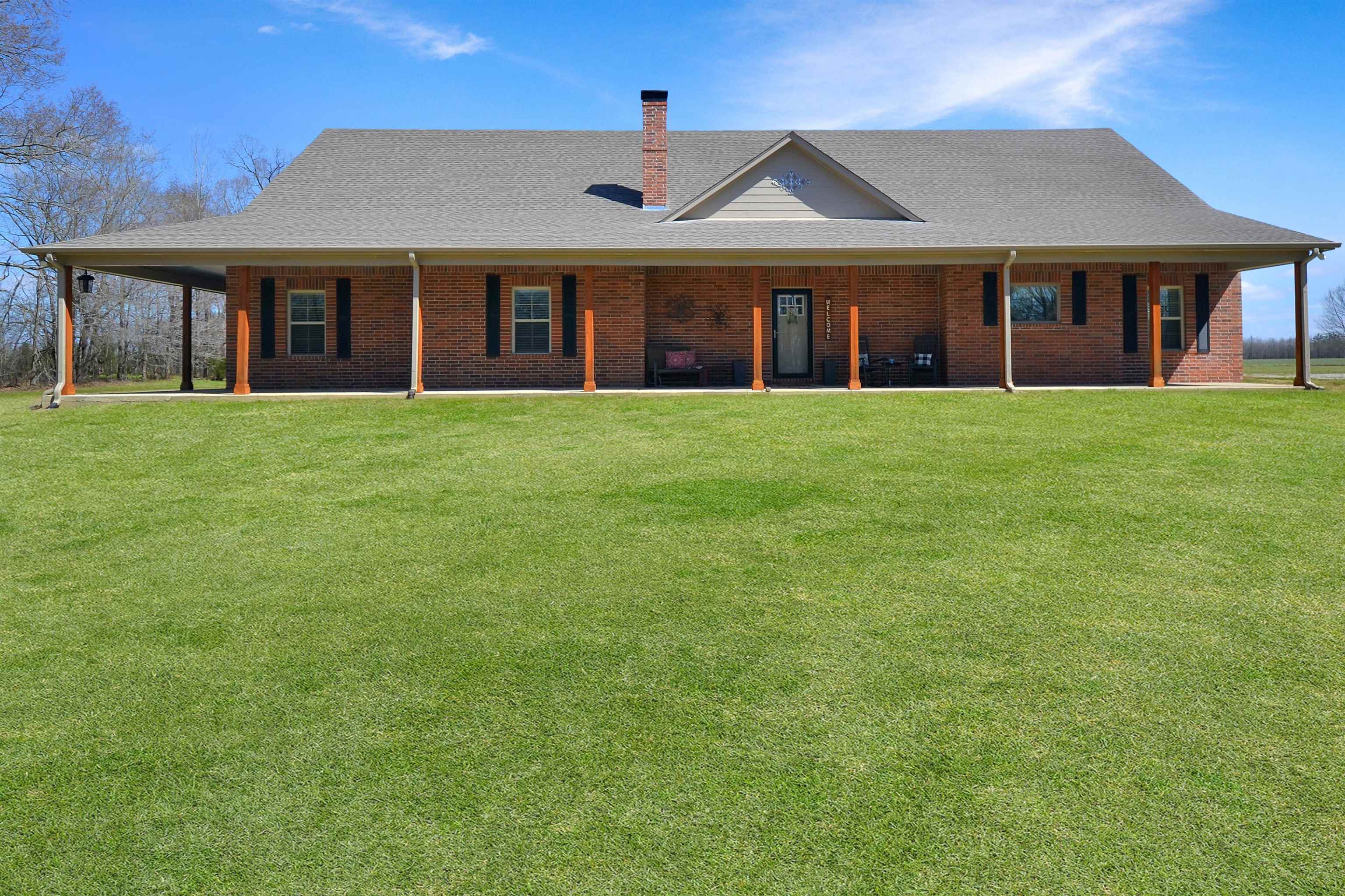 425 Honeysuckle Road Moscow, TN 38057 - Photo 1 of 25 front view of a brick house with a yard