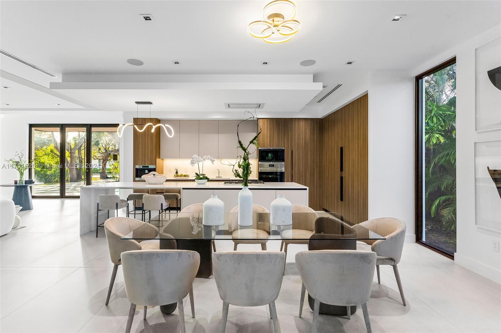 7635 Southwest 72nd Avenue Miami, FL 33143 - Photo 21 of 75 a dining hall with stainless steel appliances kitchen island granite countertop a dining table chairs and a large window