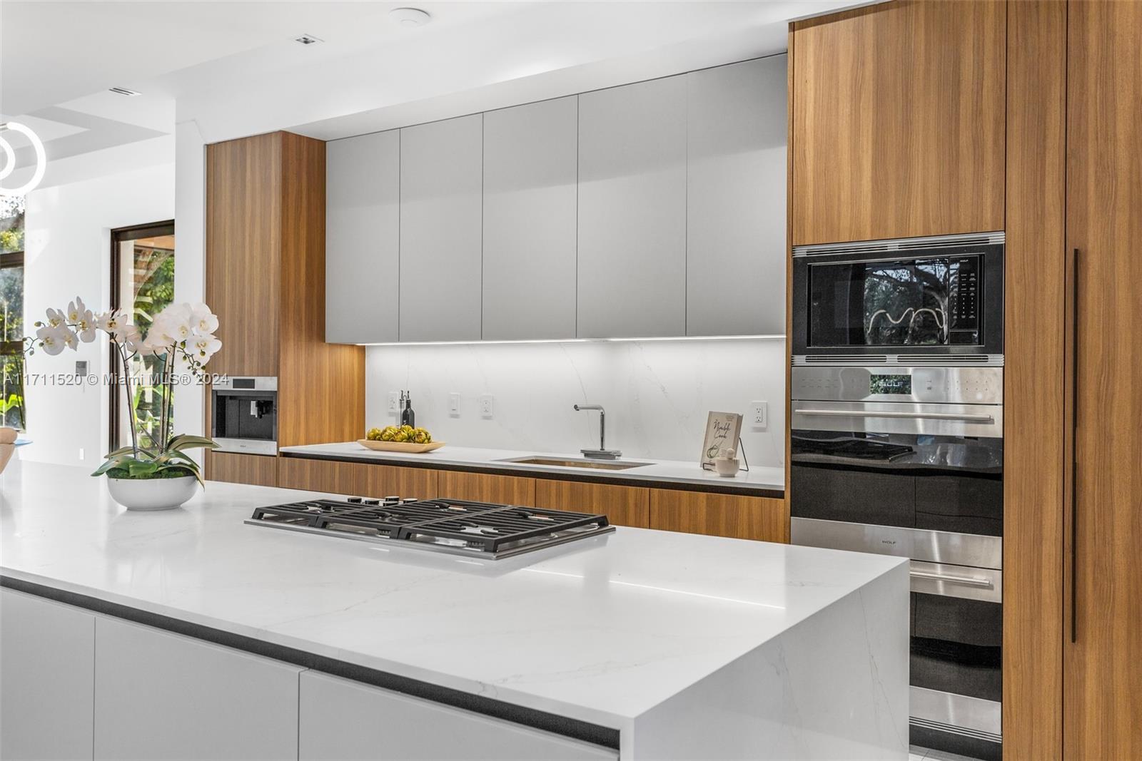 7635 Southwest 72nd Avenue Miami, FL 33143 - Photo 23 of 75 a kitchen with stainless steel appliances a stove a sink and a microwave