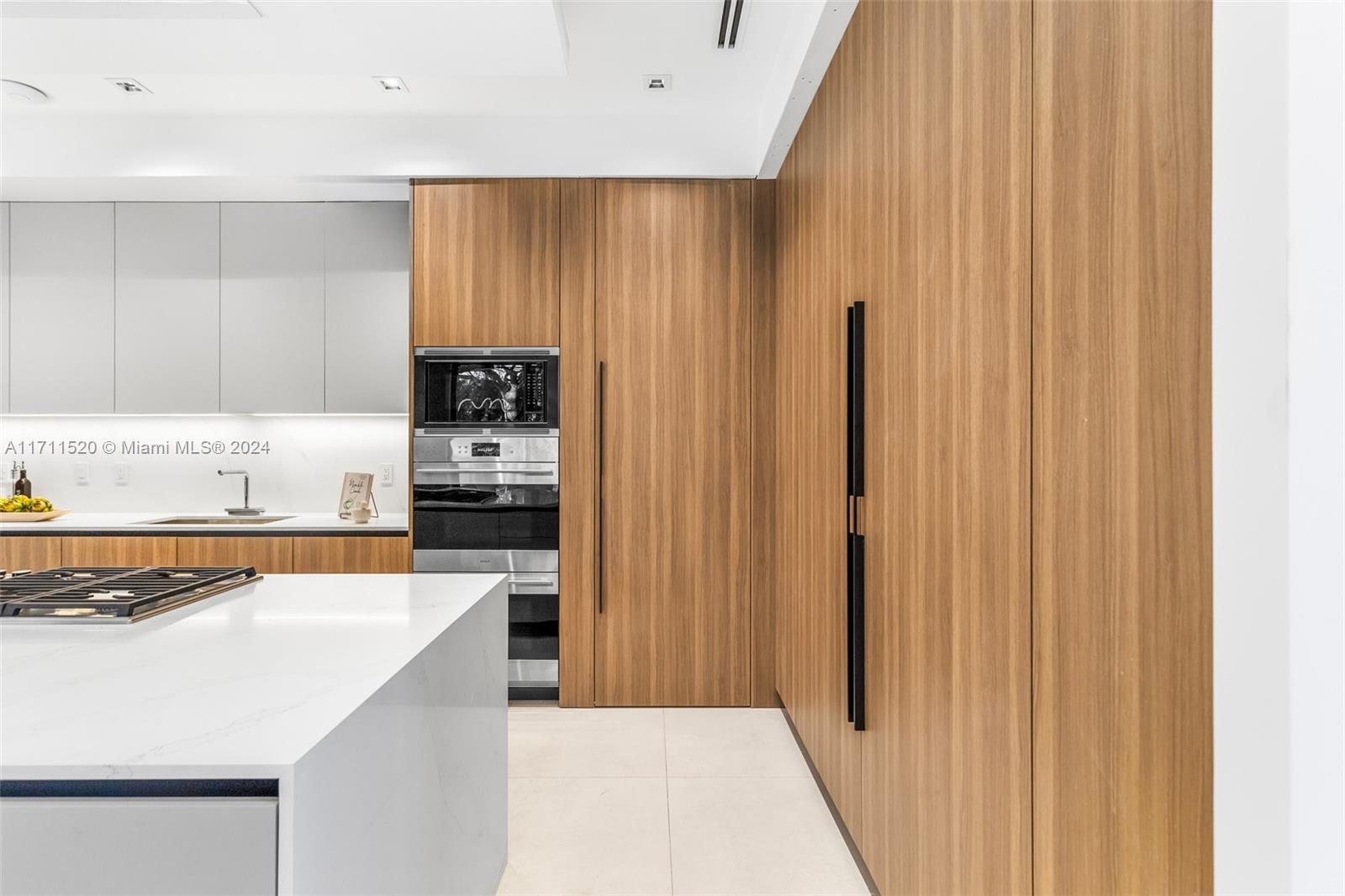 7635 Southwest 72nd Avenue Miami, FL 33143 - Photo 25 of 75 a kitchen with stainless steel appliances granite countertop a refrigerator and a sink