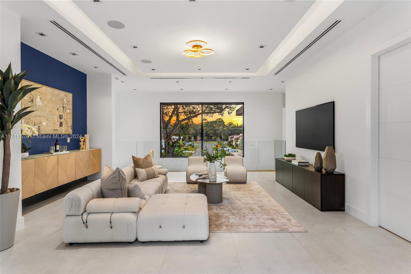 7635 Southwest 72nd Avenue Miami, FL 33143 - Photo 37 of 75 a living room with furniture and a flat screen tv