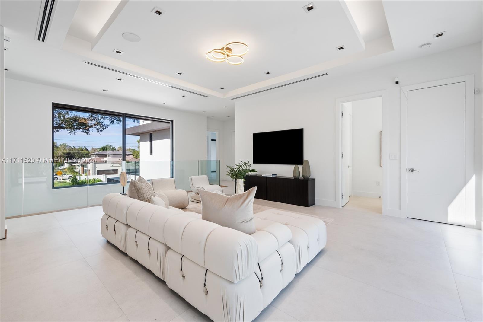 7635 Southwest 72nd Avenue Miami, FL 33143 - Photo 40 of 75 a living room with furniture and a flat screen tv