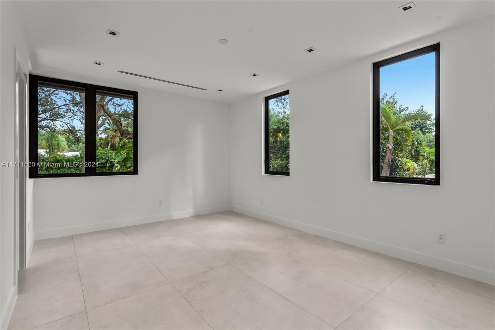 7635 Southwest 72nd Avenue Miami, FL 33143 - Photo 56 of 75 a view of an empty room with window and wooden floor