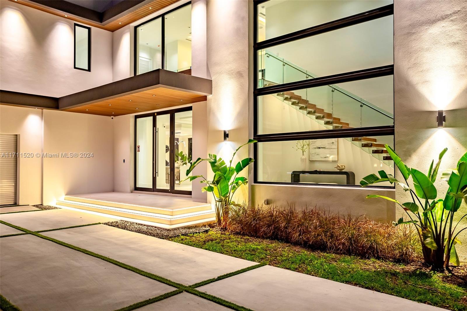 7635 Southwest 72nd Avenue Miami, FL 33143 - Photo 6 of 75 a front view of a house with a garden and pathway