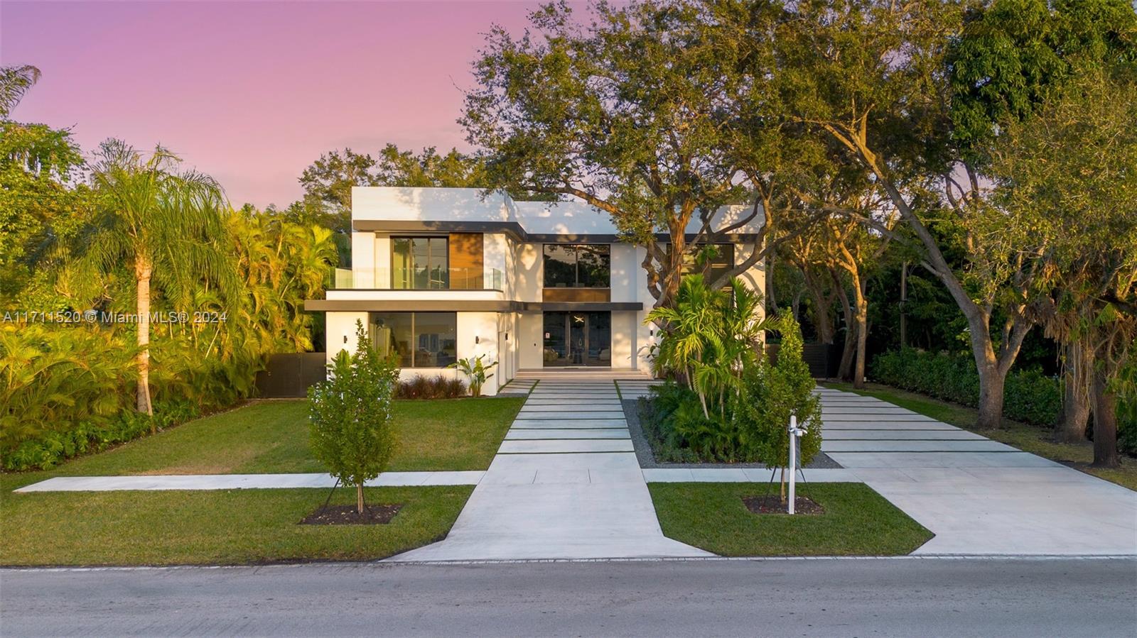 7635 Southwest 72nd Avenue Miami, FL 33143 - Photo 7 of 75 a front view of a house with a garden