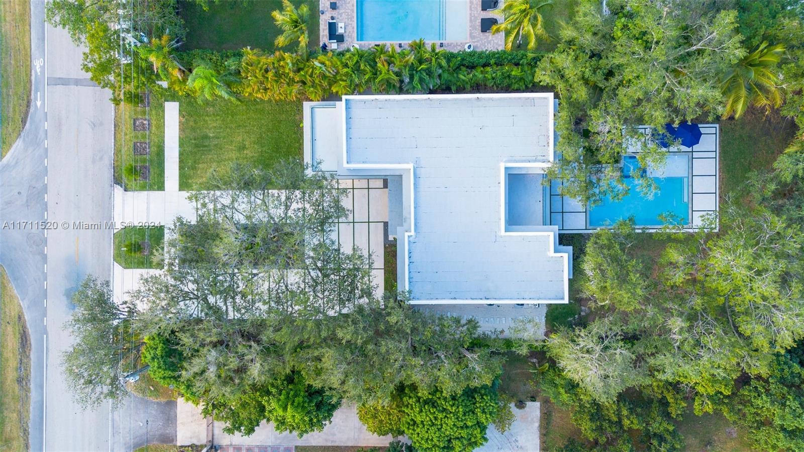 7635 Southwest 72nd Avenue Miami, FL 33143 - Photo 72 of 75 front view of house with a yard and trees all around