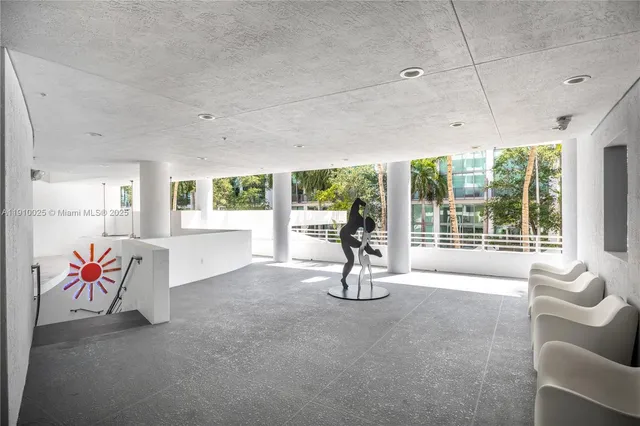 a living room with furniture and floor to ceiling window